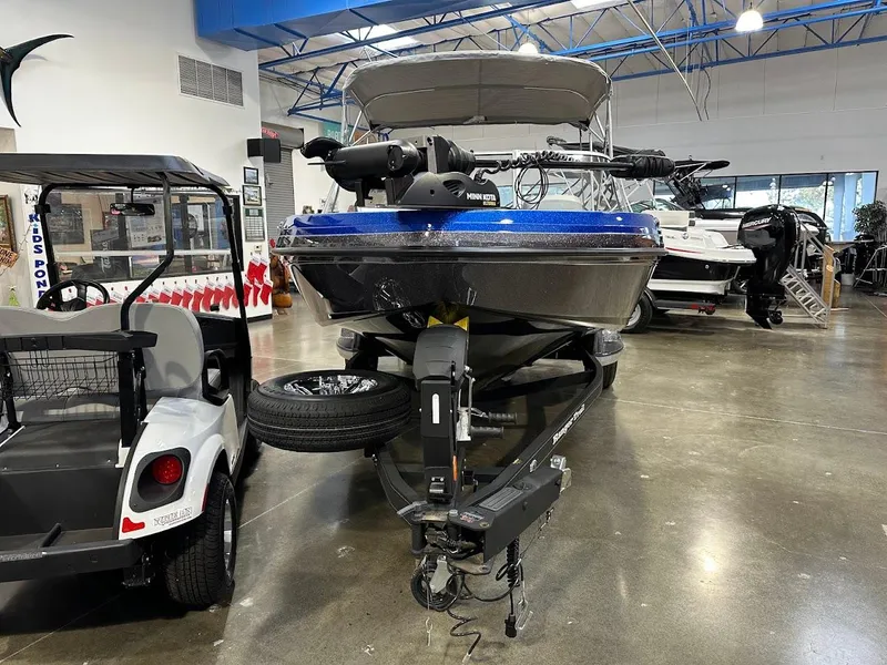 Slide: The Image of 2024 Ranger 1850MS boat in showroom, blue hull, trailer attached. - 4