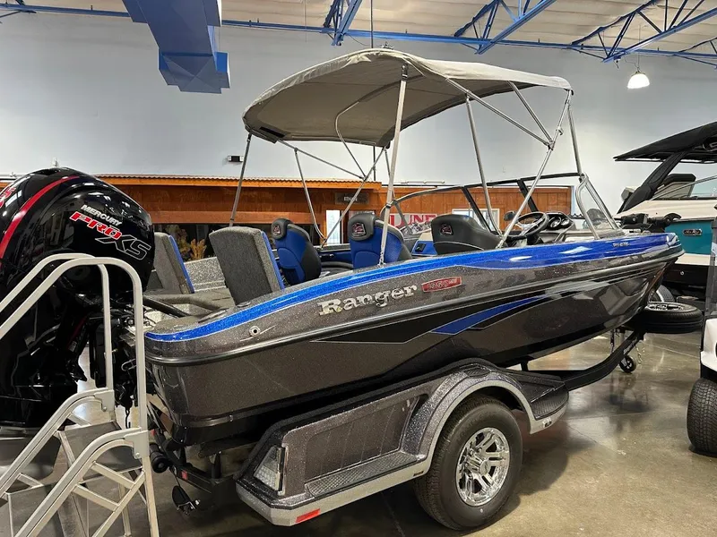 Slide: The Image of 2024 Ranger 1850MS boat with canopy in showroom, featuring sleek design and modern features. - 7