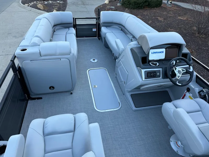 Slide: The Image of 2024 Regency 230 DL3 pontoon boat interior with plush seating and modern dashboard. - 3