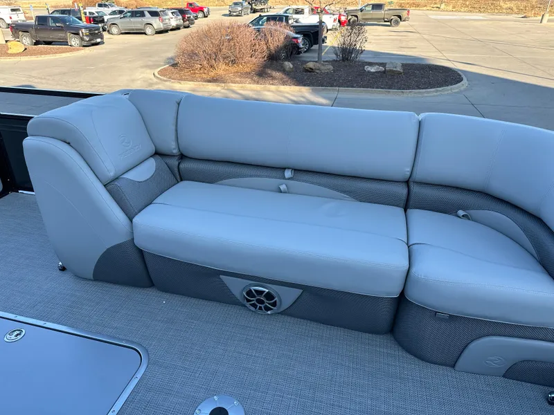 Slide: The Image of 2024 Regency 230 DL3 boat with gray seating in a parking lot. - 5