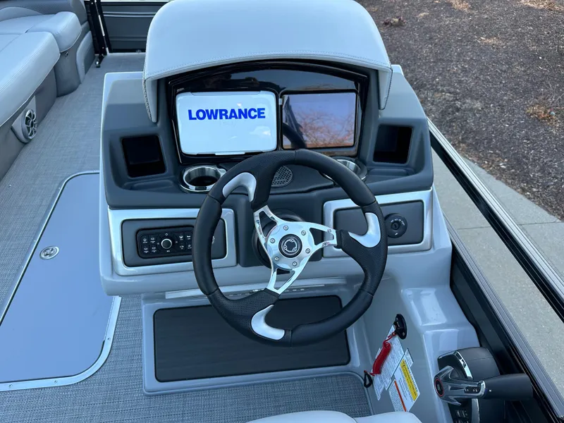 Slide: The Image of 2024 Regency 230 DL3 boat dashboard with Lowrance display and steering wheel. - 6