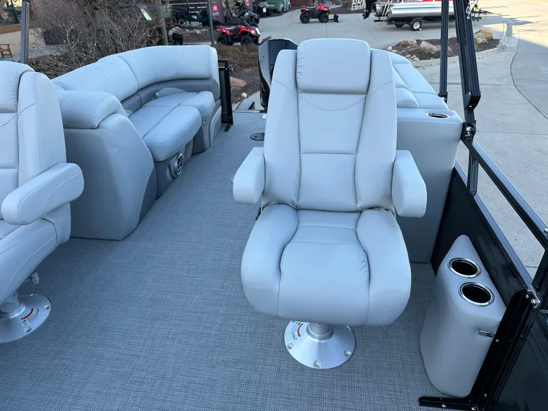 Slide: The Image of 2024 Regency 230 DL3 boat interior with plush seating and cup holders. - 8