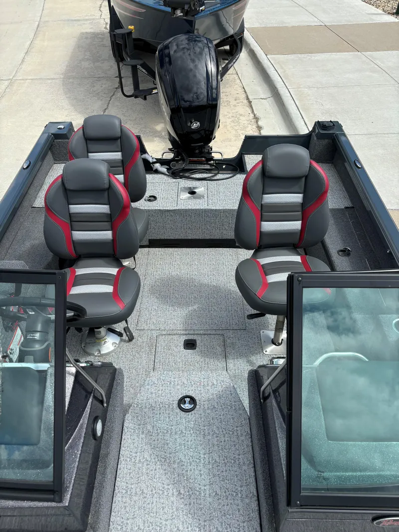 Slide: The Image of 2024 Ranger VS1682SC Angler boat interior with four seats and motor. - 4