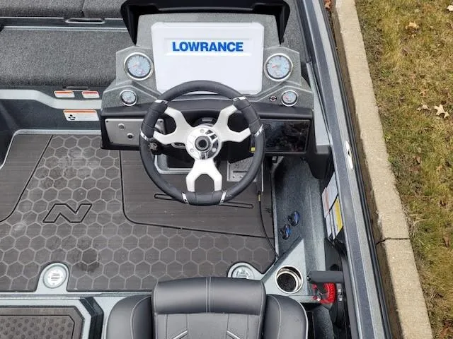 Slide: The Image of 2024 Nitro Z21 XL Pro boat dashboard with Lowrance display and steering wheel. - 3