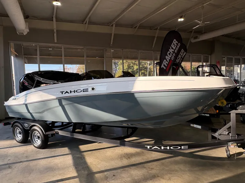 The Image of 2024 Tahoe T21 boat on trailer in showroom, side view. - 0