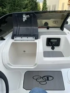 Slide: The Image of 2024 Tahoe T21 boat interior with sink, control panel, and logo mat. - 9