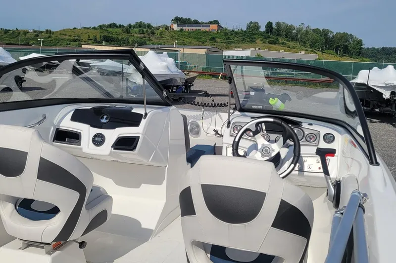 Slide: The Image of 2024 Tahoe 200 S boat interior with steering wheel and dashboard controls. - 2