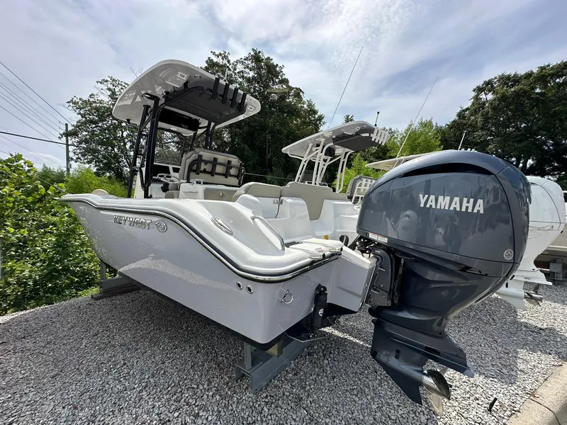 Slide: The Image of 2024 Key West 239 FS boat with Yamaha engine on gravel lot. - 1