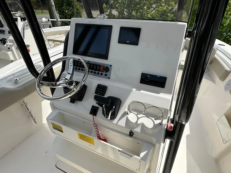 Slide: The Image of 2024 Key West 239 FS boat console with steering wheel and electronic controls. - 10