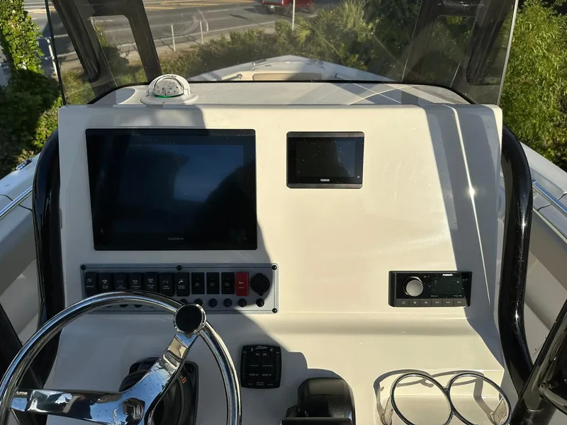 Slide: The Image of 2024 Key West 239 FS boat dashboard with steering wheel and electronic displays. - 11