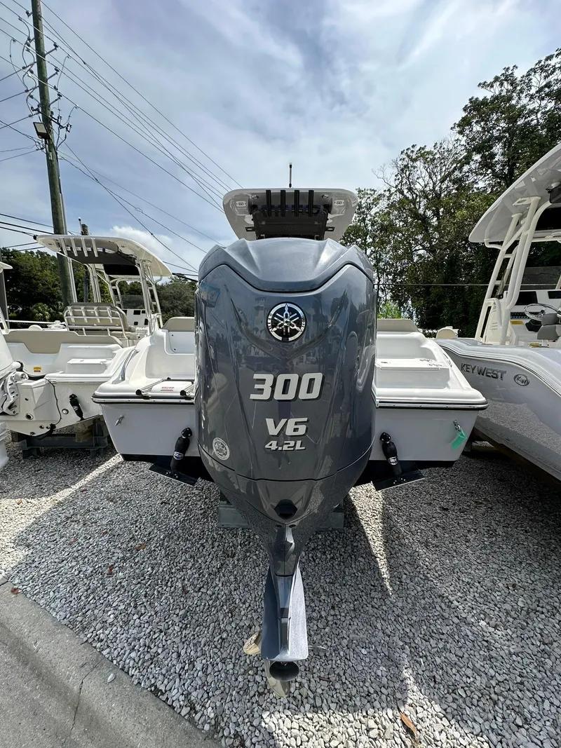 Slide: The Image of 2024 Key West 239 FS boat with Yamaha 300 V6 engine, displayed outdoors. - 2