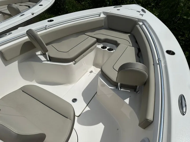 Slide: The Image of 2024 Key West 239 FS boat interior with cushioned seating and cup holders. - 4