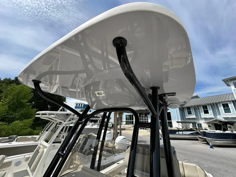 Slide: The Image of 2024 Key West 239 FS boat with T-top, docked under clear sky. - 6