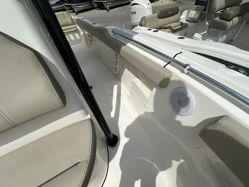 Slide: The Image of 2024 Key West 239 FS boat interior with beige seating and speaker. - 7