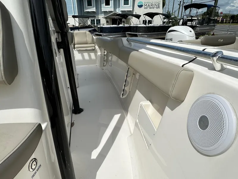 Slide: The Image of 2024 Key West 239 FS boat interior with cushioned seating and speaker. - 8