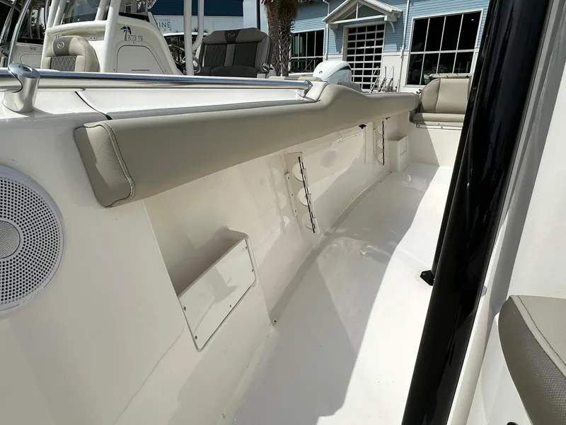 Slide: The Image of 2024 Key West 239 FS boat interior with cushioned seating and sleek design. - 9