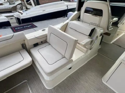 Slide: The Image of 2023 Chris-Craft Calypso 35 boat interior with white seating and modern design. - 12