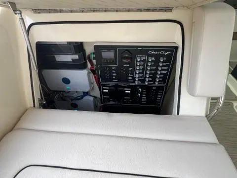 Slide: The Image of 2023 Chris-Craft Calypso 35 control panel with cushioned seating. - 13