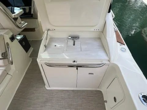 Slide: The Image of 2023 Chris-Craft Calypso 35 boat interior with open storage compartment. - 16