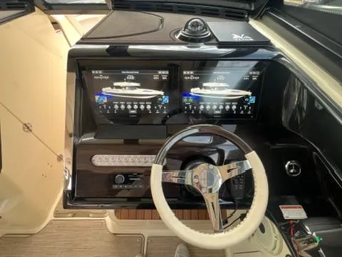 Slide: The Image of 2023 Chris-Craft Calypso 35 dashboard with dual displays and steering wheel. - 18