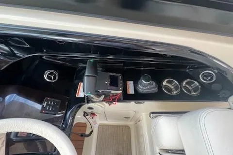 Slide: The Image of 2023 Chris-Craft Calypso 35 helm with controls and steering wheel. - 19