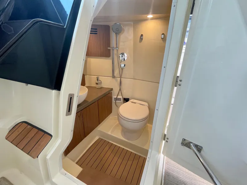 Slide: The Image of 2023 Chris-Craft Calypso 35 boat bathroom with modern fixtures and wooden accents. - 22