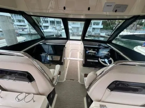 Slide: The Image of 2023 Chris-Craft Calypso 35 boat interior with modern dashboard and seating. - 23