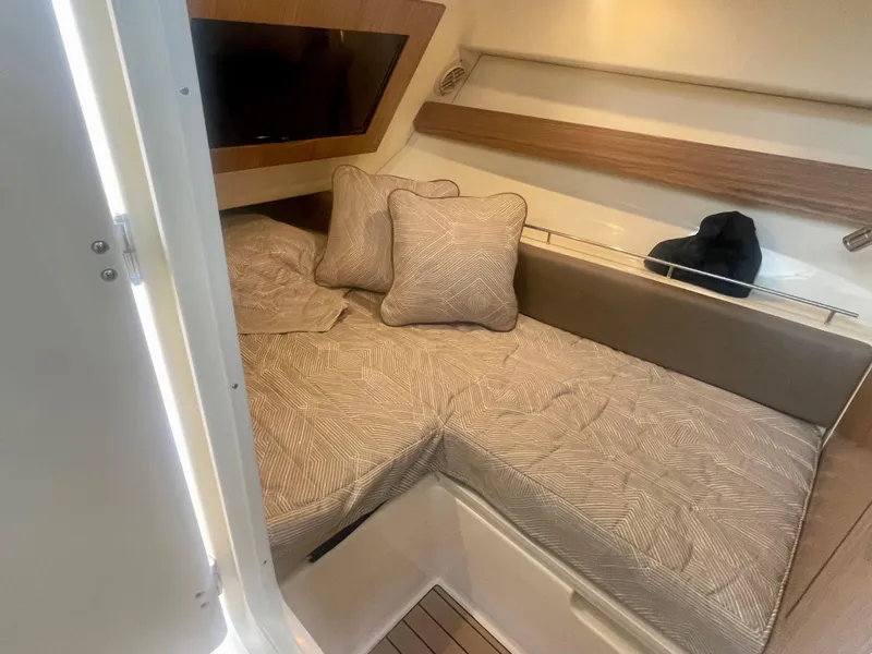 Slide: The Image of 2023 Chris-Craft Calypso 35 cabin interior with cozy bedding and cushions. - 24