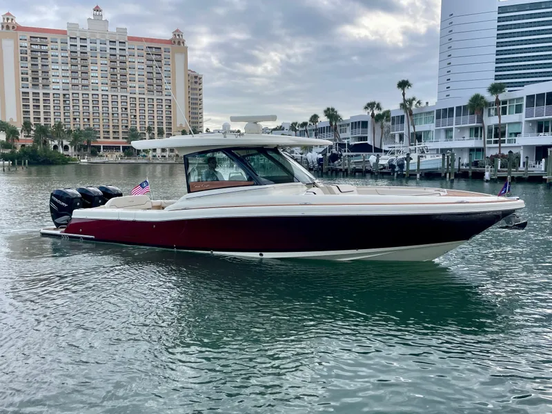 Slide: The Image of 2023 Chris-Craft Calypso 35 boat on water, with modern buildings in the background. - 3