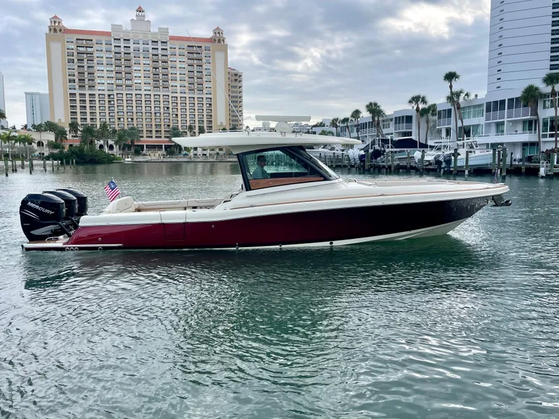 Slide: The Image of 2023 Chris-Craft Calypso 35 boat on water, urban skyline background. - 5