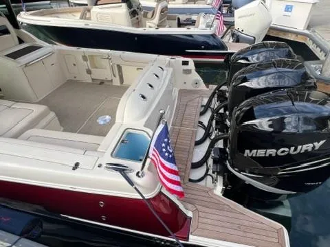 Slide: The Image of 2023 Chris-Craft Calypso 35 boat with triple Mercury engines and American flag. - 7