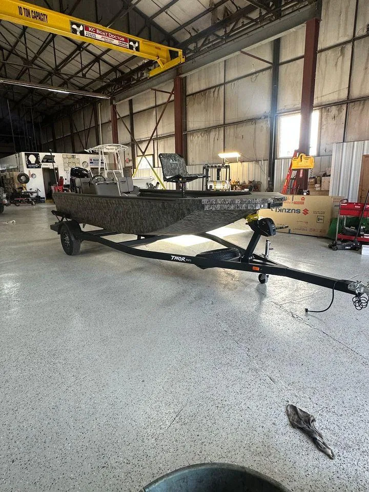 The Image of 2024 Thor Lake Hammer 1860 SC boat in a spacious warehouse. - 1