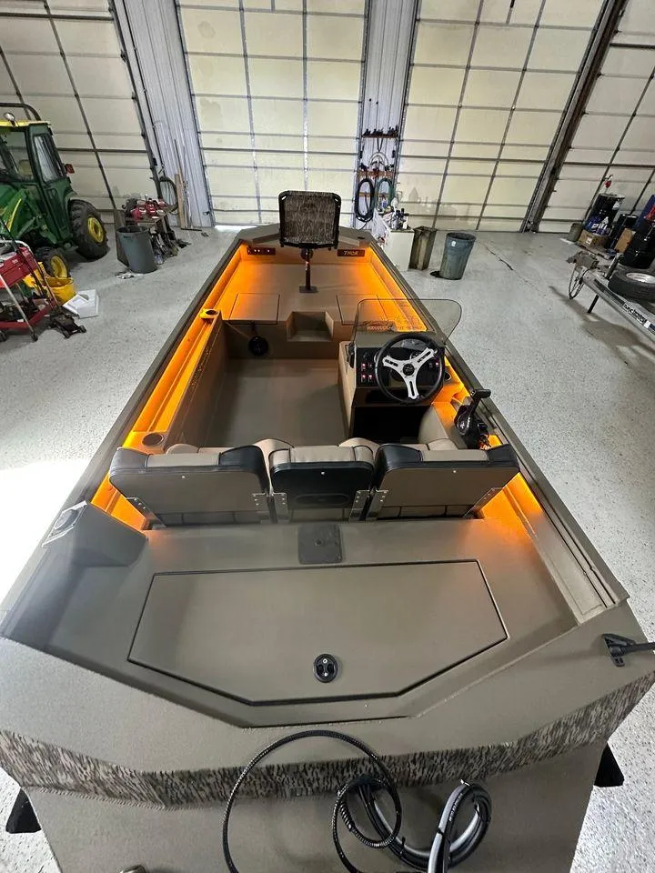 Slide: The Image of 2024 Thor Lake Hammer 1860 SC boat with illuminated interior in a garage setting. - 3