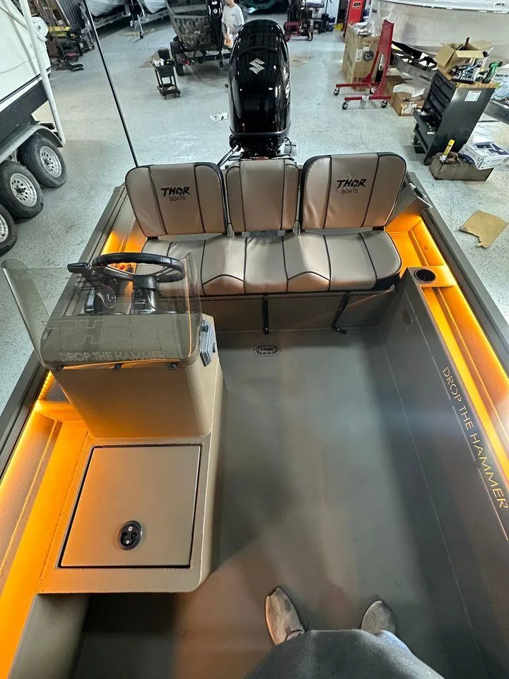 Slide: The Image of 2024 Thor Lake Hammer 1860 SC boat interior with illuminated seating and steering console. - 4