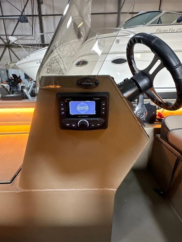 Slide: The Image of 2024 Thor Lake Hammer 1860 SC boat dashboard with steering wheel and control panel. - 6