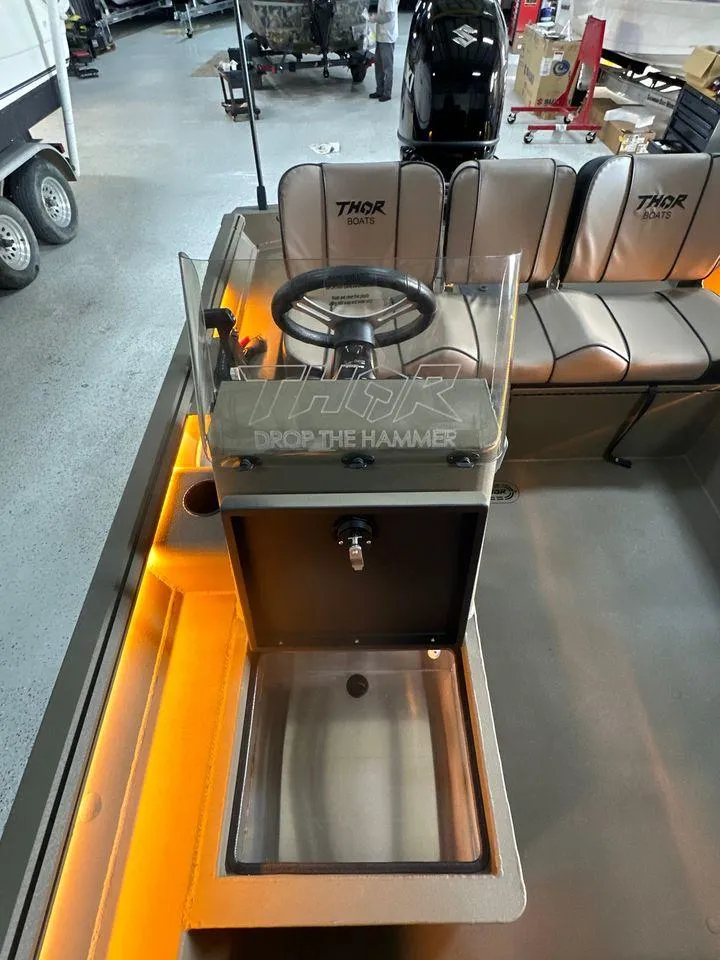 Slide: The Image of 2024 Thor Lake Hammer 1860 SC boat interior with steering console and seating. - 7