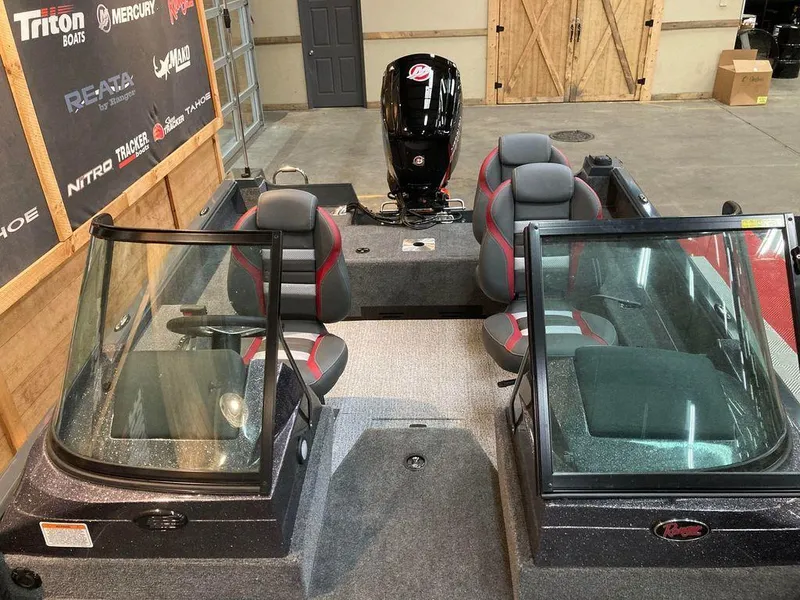 Slide: The Image of 2024 Ranger VS1682SC Angler boat interior with dual seats and windshield in a showroom. - 7