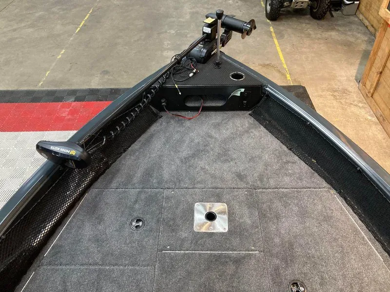 Slide: The Image of 2024 Ranger VS1682SC Angler boat deck with trolling motor and carpeted surface. - 8