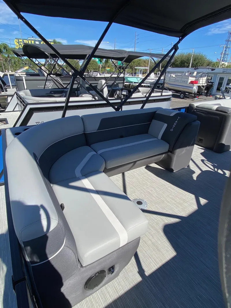 Slide: The Image of 2024 Viaggio Lago 20C pontoon boat with stylish seating and canopy under clear blue sky. - 17