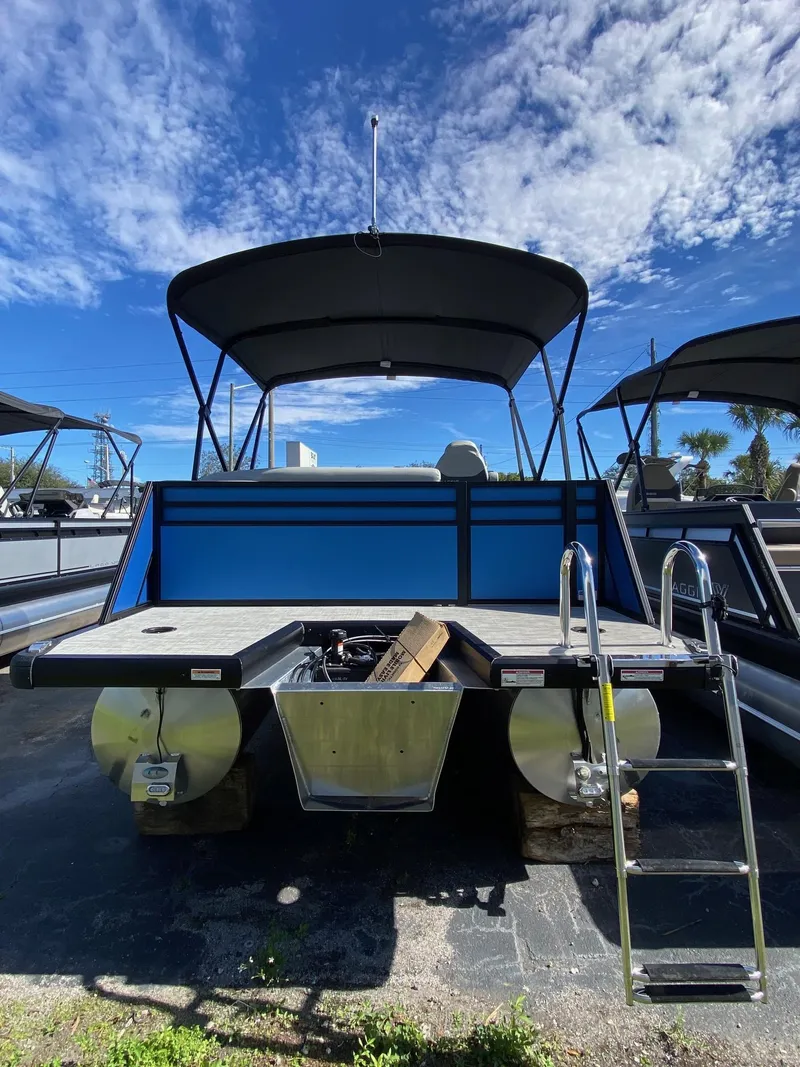 Slide: The Image of 2024 Viaggio Lago 20C pontoon boat with canopy under a clear blue sky. - 3