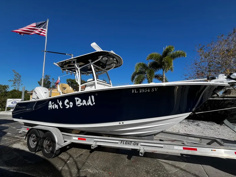 Slide: The Image of 2021 Sportsman Heritage 251 Center Console boat on trailer with Ain't So Bad! text. - 0