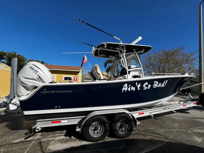 Slide: The Image of 2021 Sportsman Heritage 251 Center Console boat on trailer, side view, named Ain't So Bad. - 1