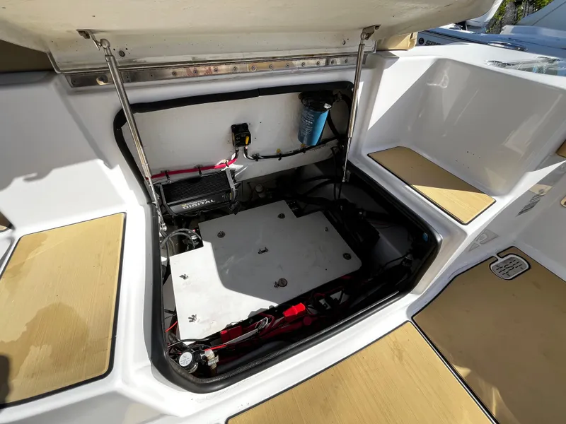 Slide: The Image of 2021 Sportsman Heritage 251 Center Console boat storage compartment with open hatch. - 10