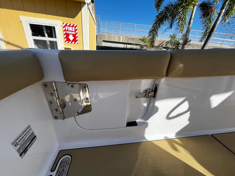 Slide: The Image of 2021 Sportsman Heritage 251 Center Console boat interior with cushioned seating and safety features. - 12