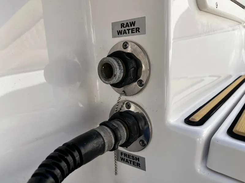 Slide: The Image of Raw and fresh water connections on a 2021 Sportsman Heritage 251 Center Console boat. - 14