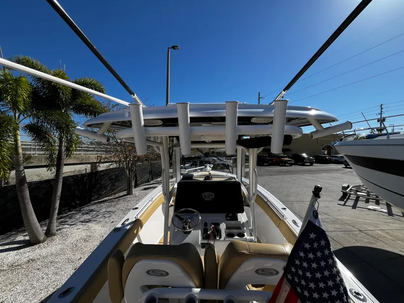 Slide: The Image of 2021 Sportsman Heritage 251 Center Console boat docked, view of helm and seating area. - 15