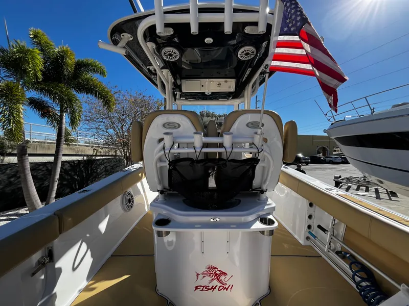 Slide: The Image of 2021 Sportsman Heritage 251 Center Console boat with American flag and palm trees. - 17
