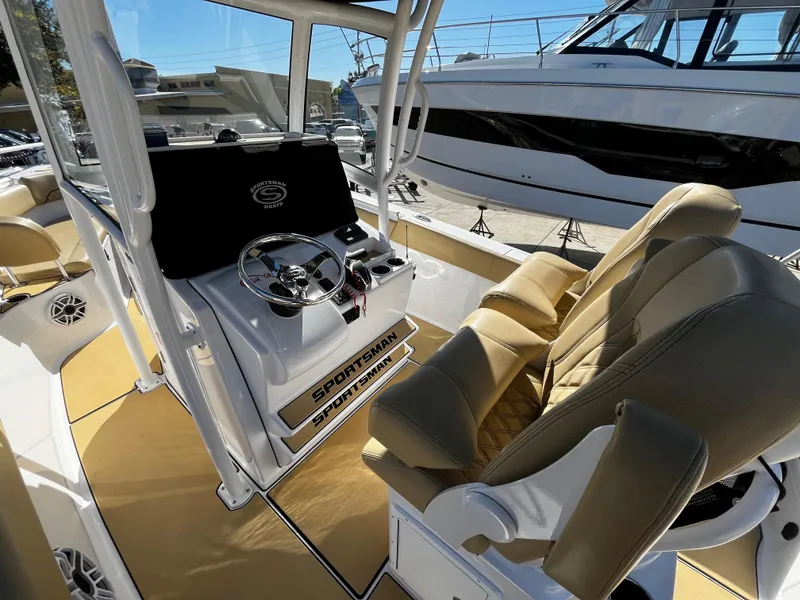Slide: The Image of 2021 Sportsman Heritage 251 Center Console boat interior with helm and seating. - 18