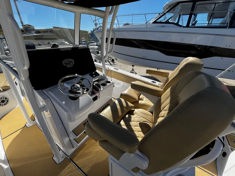 Slide: The Image of 2021 Sportsman Heritage 251 Center Console boat interior with helm and seating. - 19