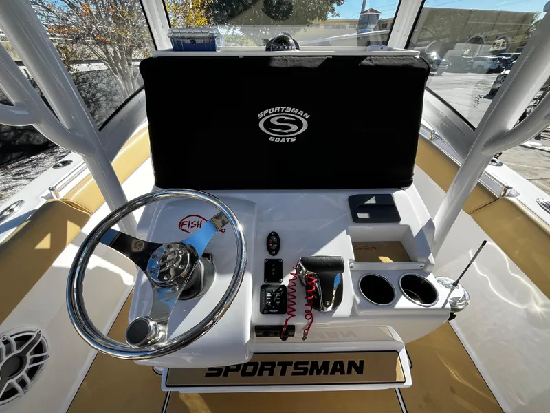 Slide: The Image of 2021 Sportsman Heritage 251 Center Console boat helm with steering wheel and controls. - 21